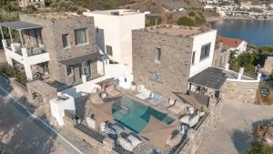 an aerial view of a house with a swimming pool at Sofrano Luxury Apartments in Evdilos