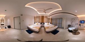 a large bedroom with two beds in a room at Hotel Krushnai Deluxe in Nandre