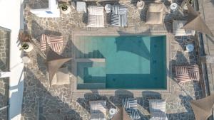 an overhead view of a swimming pool in a building at Sofrano Luxury Apartments in Evdilos