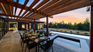 a patio with a table and chairs next to a pool at Olive Oak by AvantStay in Glen Ellen