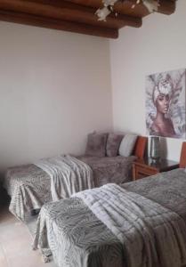 a room with two beds and a couch at Villa archontiko in Kamilari