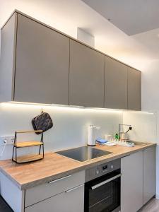 a kitchen with white cabinets and a counter top at Chalet Helsinki in Bleckede