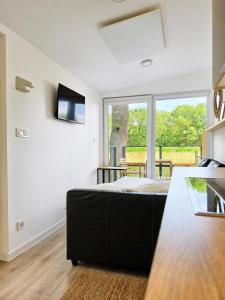 a kitchen with a bed in a room with a window at Chalet Helsinki in Bleckede