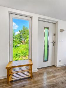 a room with a window and a wooden bench at Chalet Helsinki in Bleckede