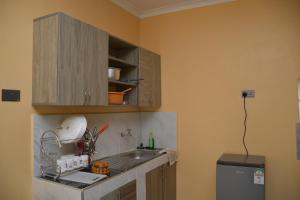 a kitchen with a sink and a counter top at Maria Villa Studio in Voi +2 photos