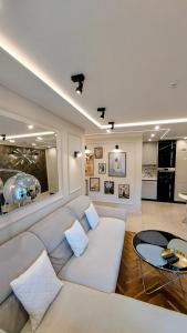 a living room with a couch and a table at THE ONE Apartment in Tomaszów Mazowiecki