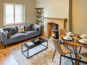 a living room with a couch and a table at Olive Cottage in Barnard Castle