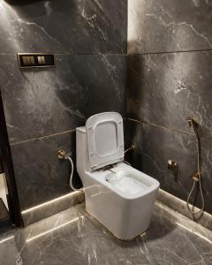 a bathroom with a white toilet in a room at Hotel nine hearts in Pānīpat