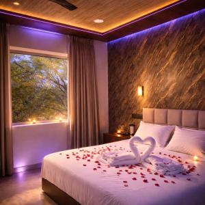 a bedroom with a bed with a swan made out of roses at Hotel nine hearts in Pānīpat