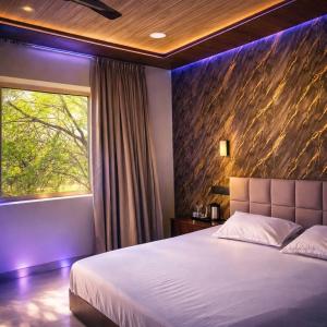 a bedroom with a large bed and a window at Hotel nine hearts in Pānīpat