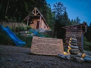 a sign in front of a playground with a rock stack at Mornov raj in Vuzenica +28 photos