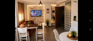 a kitchen and living room with a table and chairs at Vasiliki apartment in Kalamata