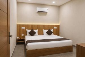 a bedroom with a bed in a room with a heater at Hotel Olive Sunny Enclave, Near Airport Road, Mohali in Kharar