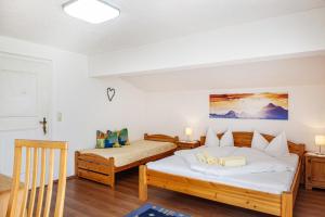a bedroom with two beds and a table at Ferienwohnung Sylvia in Ramsau im Zillertal