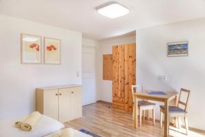 a living room with a table and a dining room at Ferienwohnung Sylvia in Ramsau im Zillertal