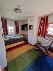 a bedroom with a bed and a chair in it at Haus Kern in Hallstatt