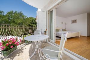 a balcony with a table and chairs and a bed at VILLA STEFANIJA small Boutique hotel&restaurant in Barban