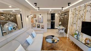a living room with a couch and a table at THE ONE Apartment in Tomaszów Mazowiecki