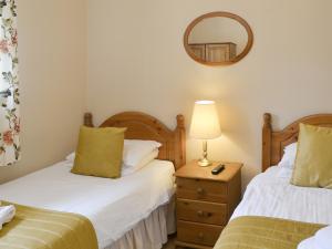 a bedroom with two beds and a mirror on the wall at Fordson in Warenford +6 photos