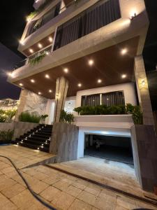 a facade of a building with stairs and lights at Saka Hotel in Plei Brel (2)
