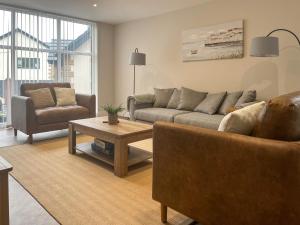 a living room with a couch and a coffee table at Barncroft Retreat - Uk51693 in Flimby