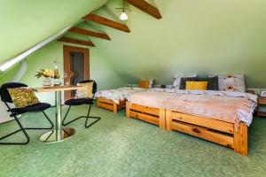 a bedroom with a bed and a desk and chairs at Jaroslav Ambrož Elvomont Chlum u Třeboně in Chlum u Třeboně +34 photos