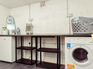 a kitchen with a counter and a washing machine at Chalet 4 in Flookburgh