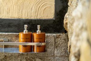 two bottles of soap sitting on a shelf at Ubud Heritage Stay by Dhananjaya Hospitality in Ubud +103 photos