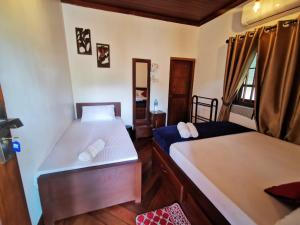 a room with two beds and a window at Inpan's beach resort Batticaloa in Batticaloa +266 photos