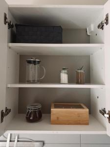 a kitchen shelf with a wooden box on it at Portside studio, free parking, self check-in in Klaipėda