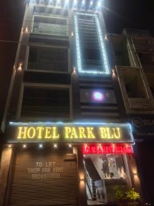 a hotel part of a building with neon lights at Hotel Park Blu in Pānīpat