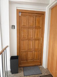 a wooden door in the corner of a room at Apartman Matej in Gospić +1 photo