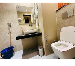 a bathroom with a white toilet and a sink at Evara Exotica in Darbhanga