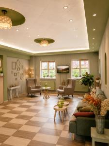 a waiting room with couches and chairs and tables at Hotel Olimp in Cluj-Napoca