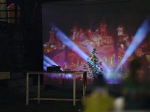 a table in front of a large screen with a tv at Maasa Retreat & Resort in Shivpuri