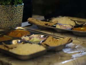 a table with two trays of food on a counter at Maasa Retreat & Resort in Shivpuri