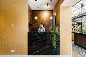 a woman talking on a cell phone in a bathroom at Mezger Lodges in Domburg +66 photos