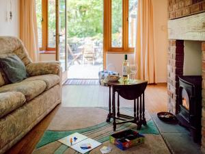 a living room with a couch and a table at Cob Cottage in Rhossili