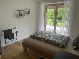a bed in a room with a window at Ferienhaus im Günztal in Lauben