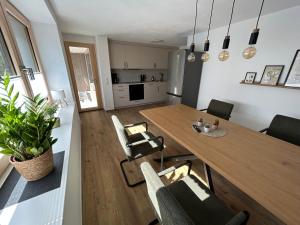 a dining room and living room with a table and chairs at Ferienhaus im Günztal in Lauben +5 photos