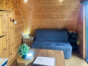 a room with a bed and a table in a sauna at Pencaerau Pods - Enlli Pod in Pwllheli
