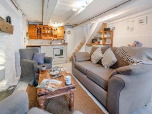 a living room with a couch and two chairs and a table at Fishermans Cottage in St Ives +23 photos
