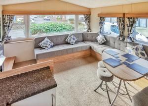 a living room with a couch and a table at Fishguard Holiday Park in Pembrokeshire