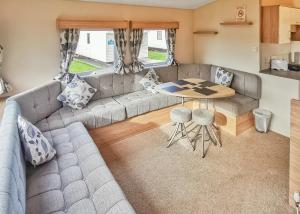 a living room with a couch and a table at Fishguard Holiday Park in Pembrokeshire +23 photos