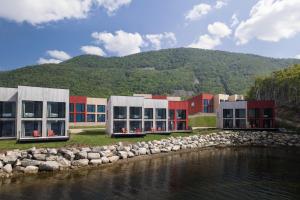 a building next to a body of water at Cormorant Rock Chalets in Ingonish Beach