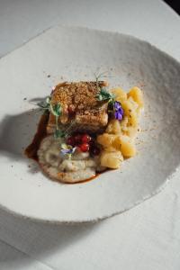 a plate of food with a piece of meat and vegetables at Hotel Son Xotano by Annua Signature in Sencelles +131 photos