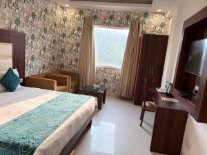 a hotel room with a bed and a window at The Arch Premium - Delhi IGI Airport in New Delhi