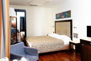 a hotel room with a bed and a tv at Residenza Mecenate in Rome
