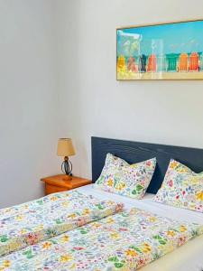 a bedroom with a bed with colorful sheets and pillows at Apartamento Aliciamin in Costa Calma