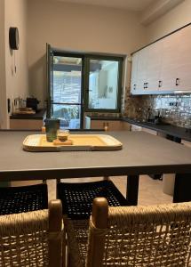 a kitchen with a large table with chairs in it at Trinity Gythion in Gythio